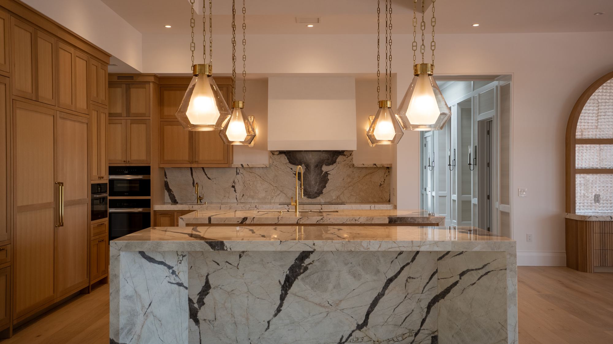 Modern kitchen with marble waterfall island